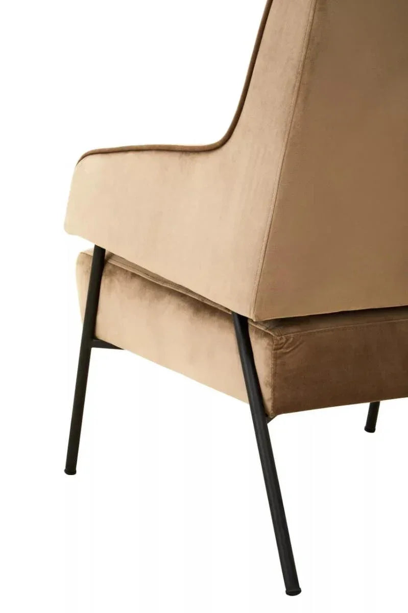Beige velvet accent chair with black metal legs side view