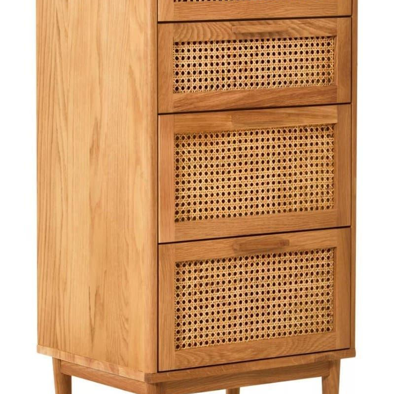 Oak chest of drawers with rattan front panels and tapered legs, shown at a side angle