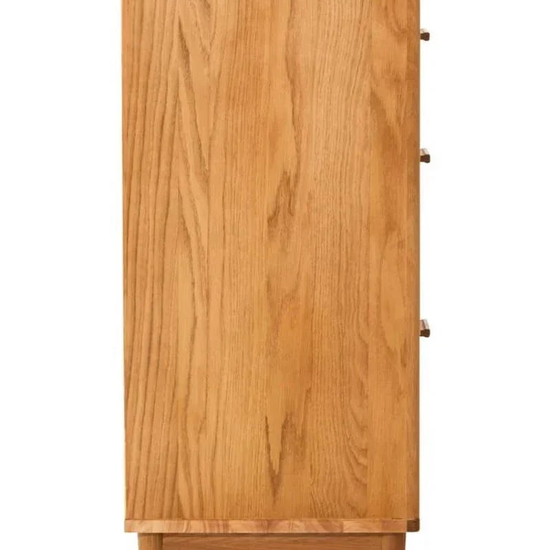 Side view of oak chest of drawers with wooden legs