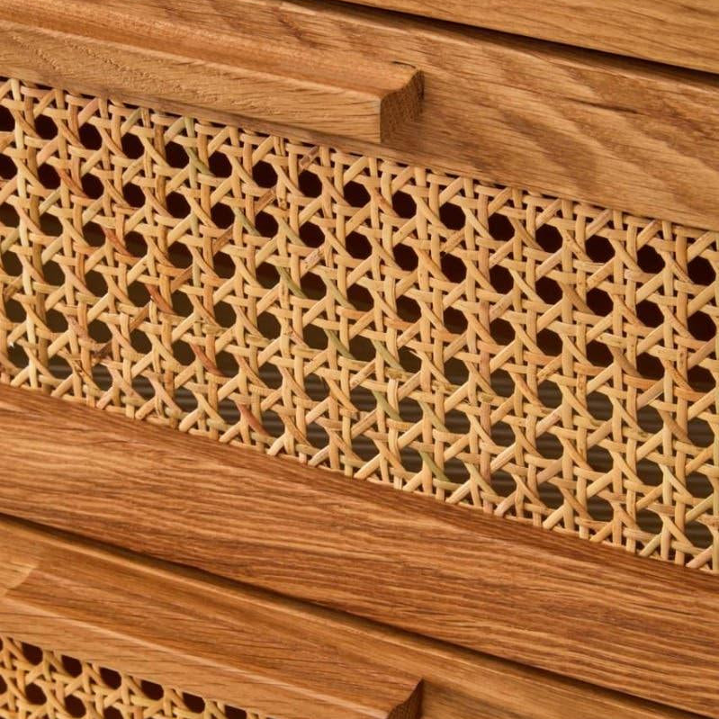 Close up of natural wood drawer with woven rattan front and integrated handle