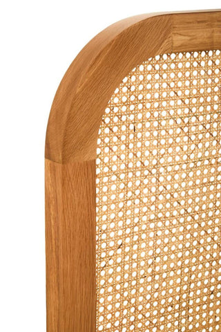 Close-up view of the Lyon Rattan and Oak Wood Double Bed Headboard, showcasing the natural oak frame with a smooth finish and intricately woven rattan panel, highlighting the rounded top edge for a soft, elegant design