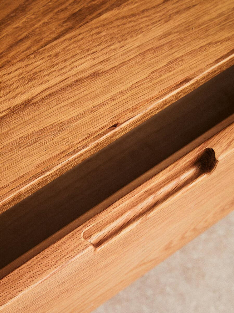 Close-up view of the Lyon Rattan and Oak Wood 2 Door Wardrobe, highlighting the smooth wooden surface and a sleek drawer with a minimalist handle. The natural grain of the oak wood is visible, showcasing its warm tones and texture