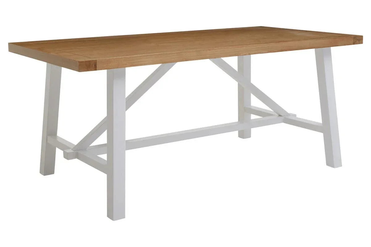 Rectangular dining table with light wood top and white painted farmhouse style legs