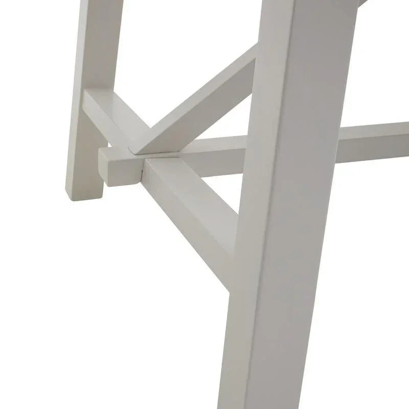 White wooden table legs with cross support detail, closeup view of furniture base