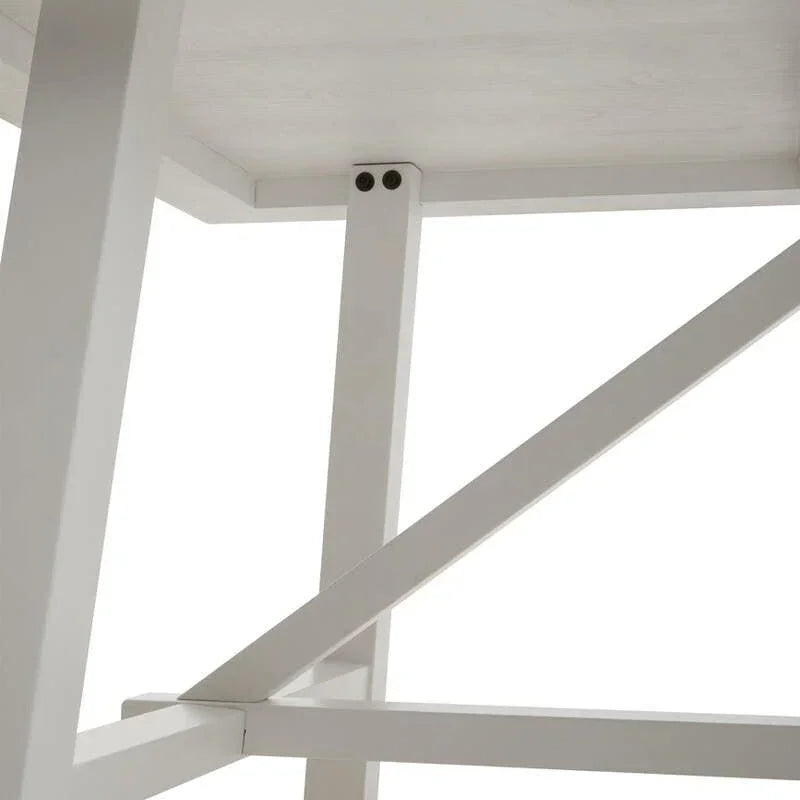 Close-up of wooden dining table base with white legs and cross frame support