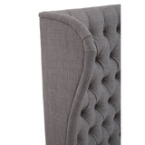 Grey kingsize headboard featuring a tufted design with a curved edge, showcasing a soft fabric texture