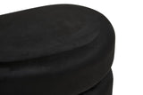 Black velvet oval pouffe with a smooth, rounded top and a soft texture, designed for comfort and style in home decor