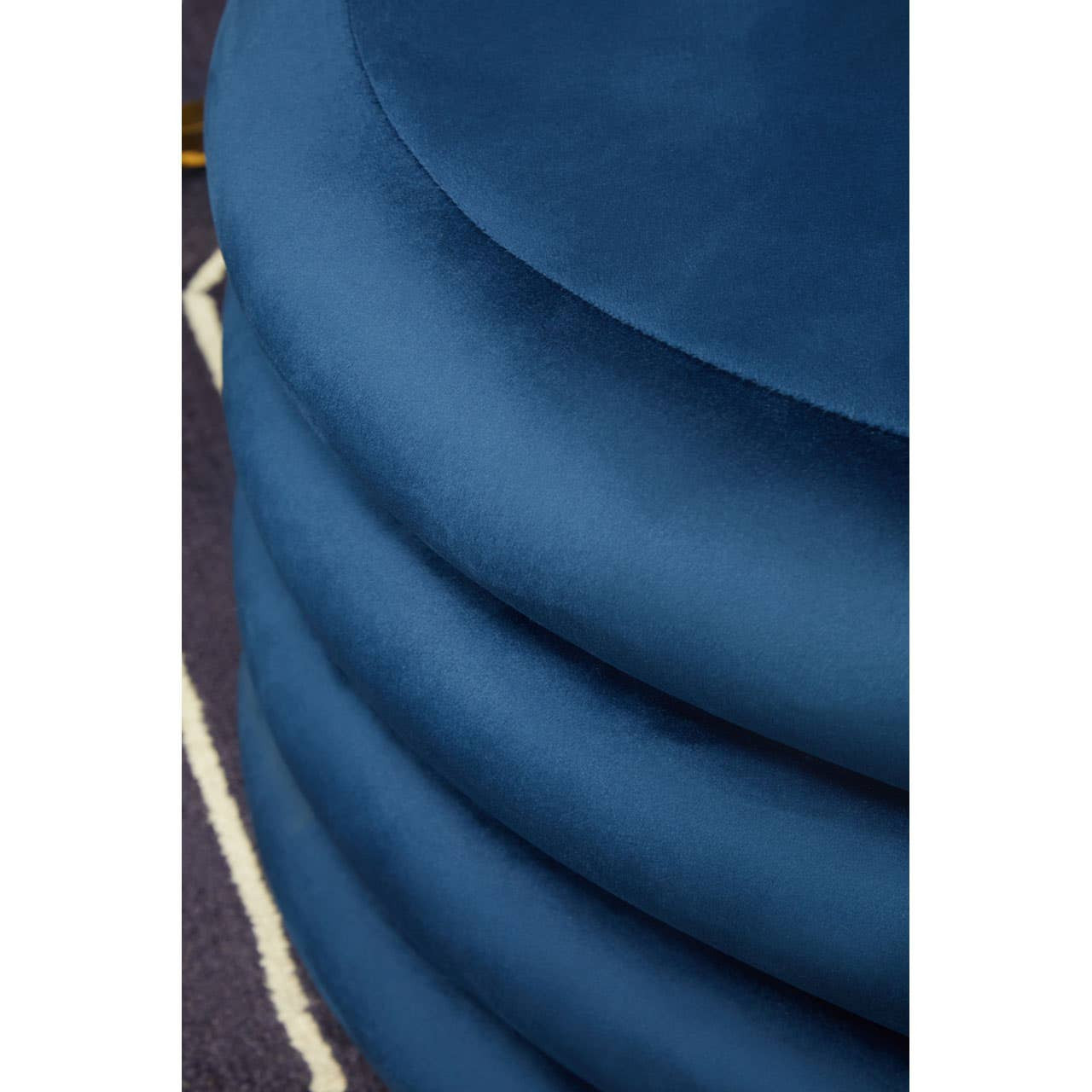 Midnight navy velvet round pouffe with a smooth, plush texture and a sleek, circular design, featuring layered fabric that creates a soft, inviting appearance. The pouffe is set against a contrasting background, highlighting its rich color and luxurious feel