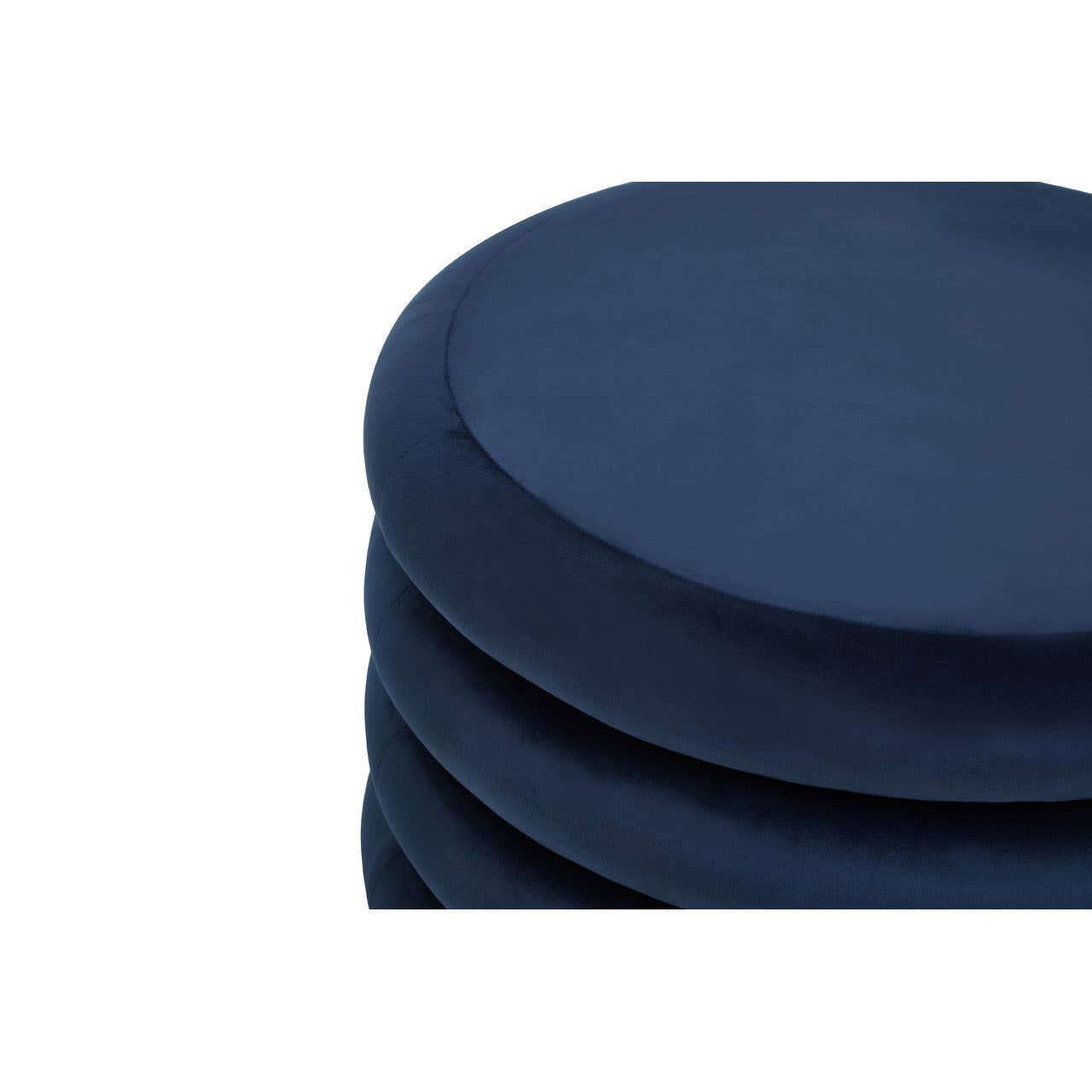 Midnight navy velvet round pouffe with a smooth, circular top and plush texture, stacked with additional pouffes in the background