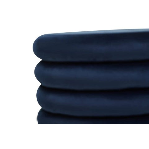 Midnight navy velvet round pouffe with a smooth, soft texture, featuring a stacked design that highlights its plush cushioning