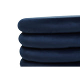 Midnight navy velvet round pouffe with a smooth, soft texture, featuring a stacked design that highlights its plush cushioning