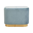 A rectangular pouffe upholstered in soft blue velvet with a smooth matte gold base, featuring rounded edges and a plush top surface