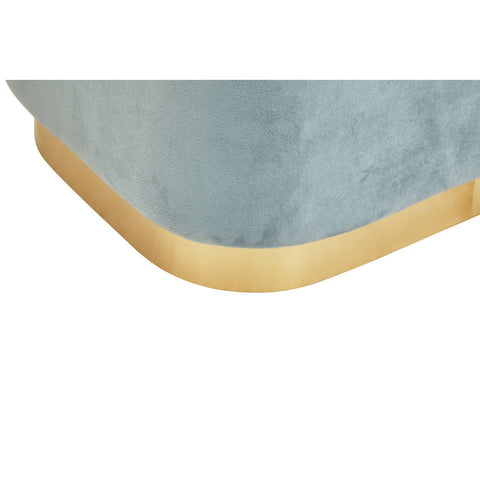 Rectangular pouffe featuring a soft blue velvet upholstery with a smooth matte gold base. The corners are rounded, highlighting the elegant design and color contrast between the fabric and the base