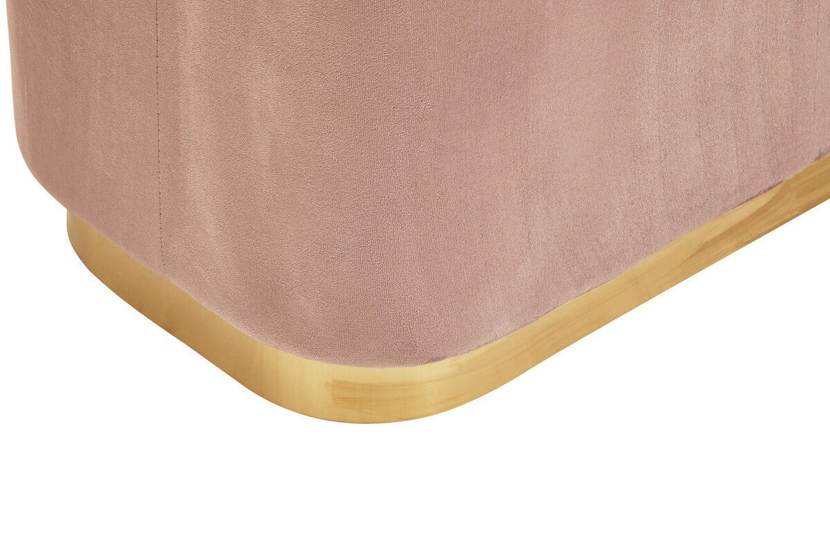 Dusty pink velvet pouffe with a rectangular shape and a matte gold base, showcasing a soft texture and rounded edges