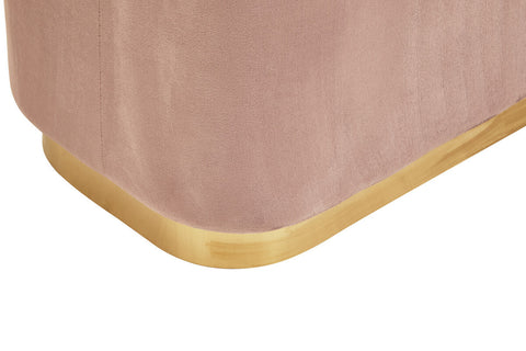 Dusty pink velvet pouffe with a rectangular shape and a matte gold base, showcasing a soft texture and rounded edges
