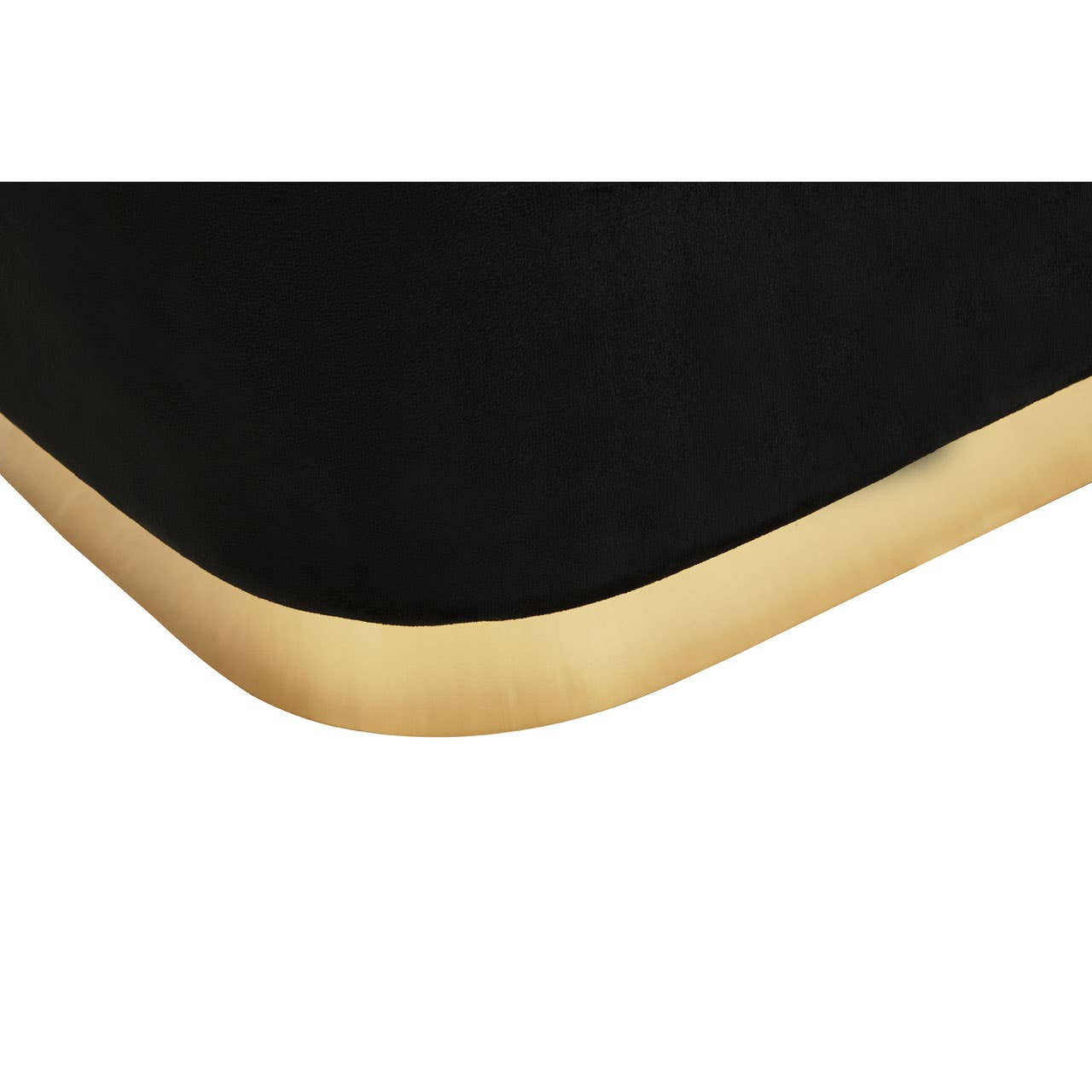 Black velvet pouffe with a smooth, rounded edge and a matte gold trim along the bottom. The pouffe has a rectangular shape and a luxurious texture, showcasing a modern design suitable for home decor