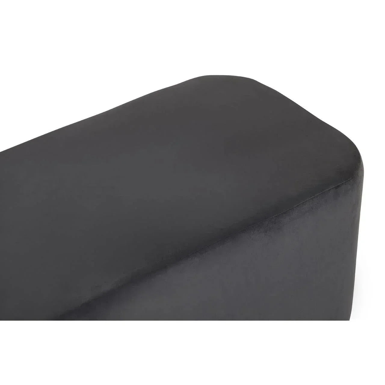 Close up of black fabric ottoman corner with smooth finish