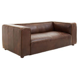 Antique brown leather two-seater sofa with a minimalist design, featuring thick armrests and a low back. The sofa has a smooth, rich texture and sits on short wooden legs, showcasing a modern yet classic aesthetic suitable for various interior styles
