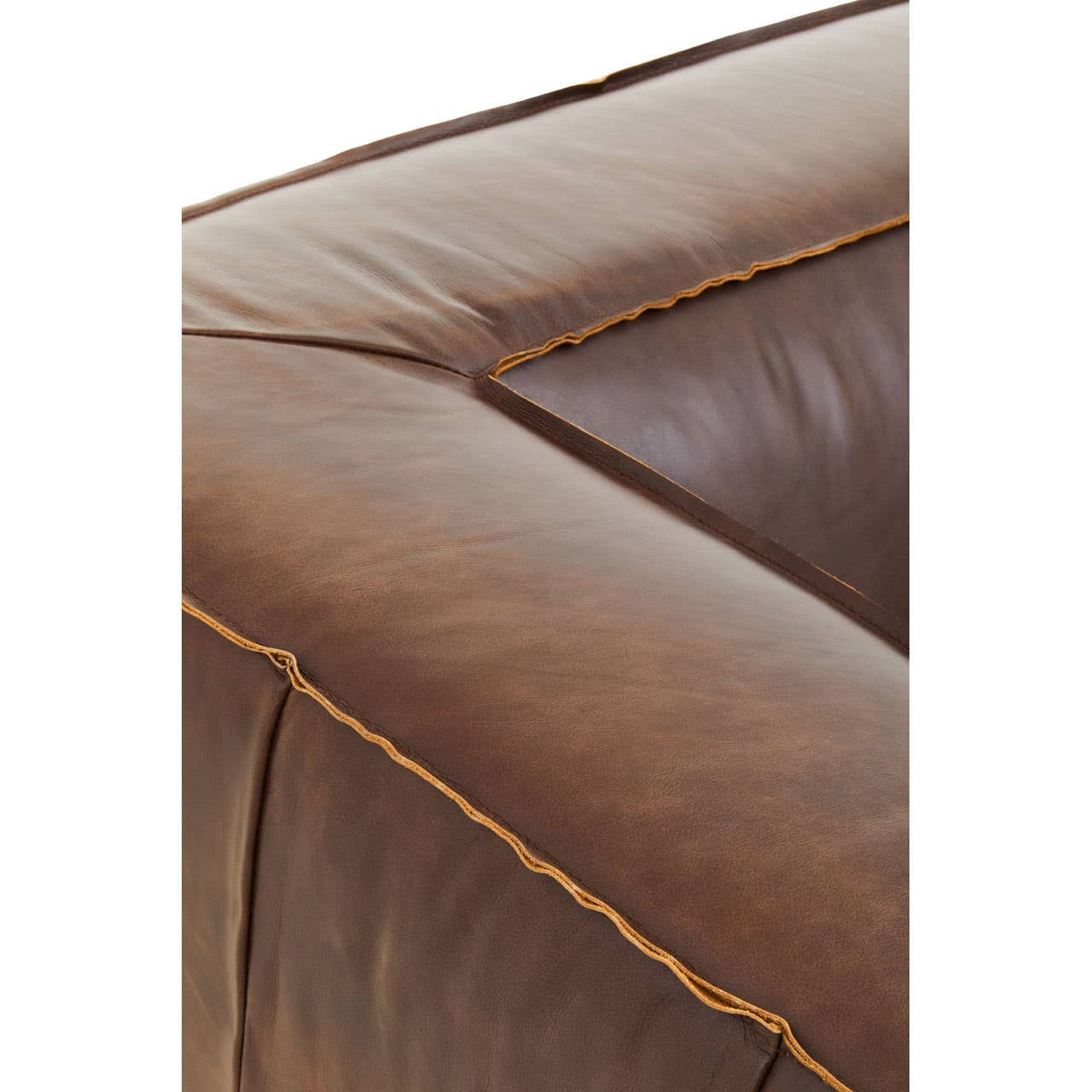 Close-up view of the corner of a King Two Seater Antique Brown Leather Sofa, showcasing the rich, textured brown leather and contrasting stitching along the edges. The sofa features a square, padded design with visible seams, emphasizing its vintage style and craftsmanship