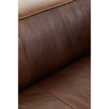 Close-up view of the antique brown leather upholstery of a two-seater sofa, showcasing the rich texture and subtle creases of the leather. The warm tones highlight the sofa's vintage appeal, with a smooth surface and a hint of sheen