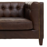Dark brown leather three-seater Chesterfield sofa featuring a tufted backrest, rolled arms, and wooden legs. The sofa has a sleek, modern design with visible stitching and a polished finish, showcasing its luxurious texture