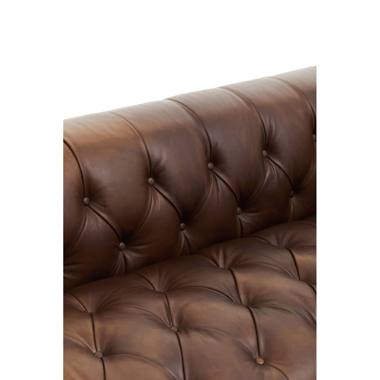 Close-up view of a dark brown leather sofa featuring a tufted design with visible stitching and plush cushioning, highlighting the luxurious texture and modern Chesterfield style