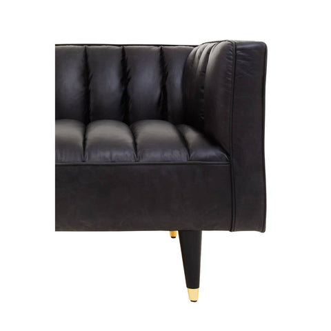 Black leather three-seater sofa featuring flared arms and tufted detailing on the seat. The sofa is supported by sleek, tapered legs with gold accents