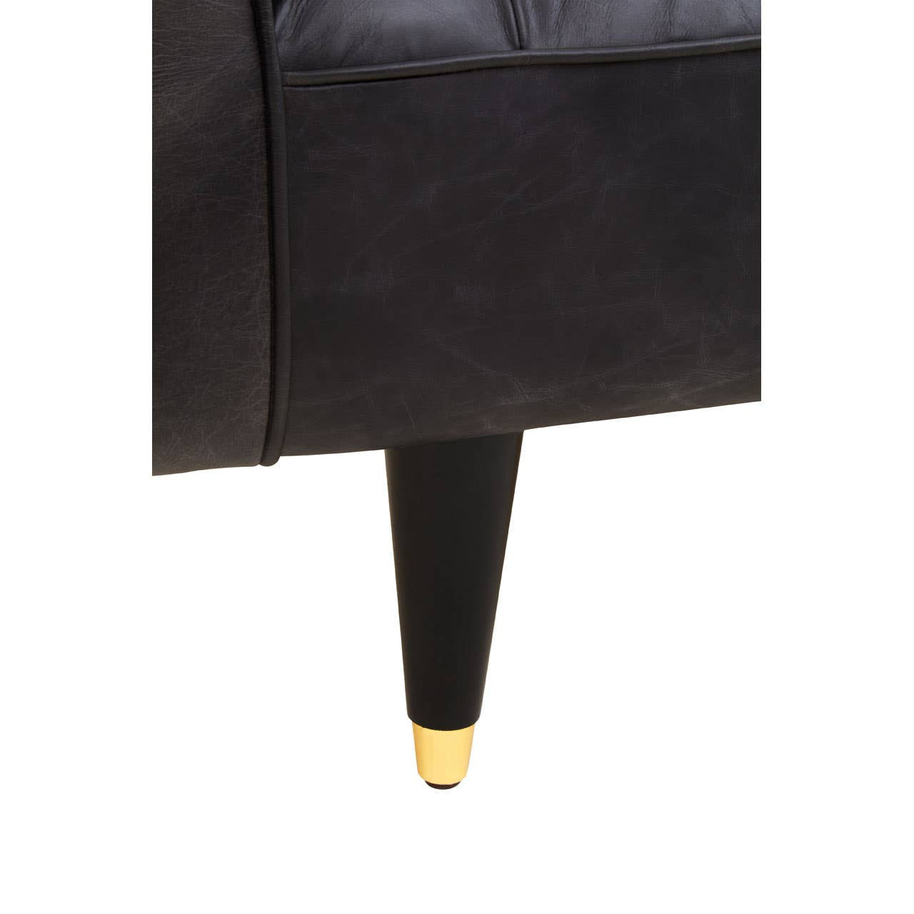 Black leather sofa with flared arms and a sleek design, featuring tapered legs with gold accents. The upholstery appears smooth and luxurious, highlighting the modern aesthetic of the piece