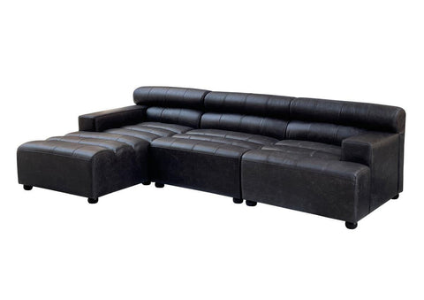 Antique black leather modular sofa chair with a sleek design, featuring no armrests and a low backrest. The sofa has a sectional layout with a chaise lounge on one side, supported by short, sturdy legs. The leather upholstery has a smooth finish, showcasing a modern yet classic aesthetic suitable for various interior styles