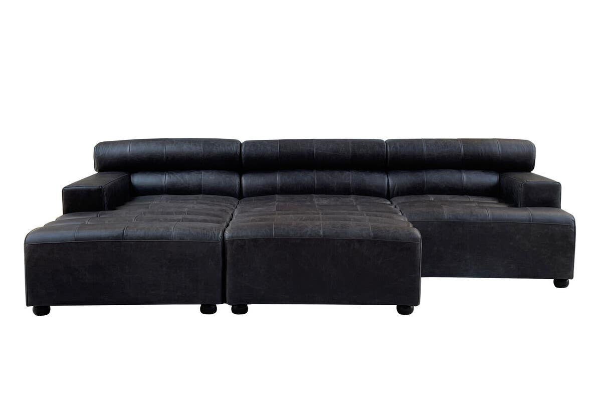 Antique black leather modular sofa chair with a sleek, armless design, featuring a low backrest and plush cushions. The chair is positioned in a modern style, showcasing its smooth leather texture and clean lines, suitable for contemporary home decor