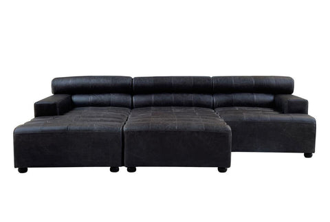 Antique black leather modular sofa chair with a sleek, armless design, featuring a low backrest and plush cushions. The chair is positioned in a modern style, showcasing its smooth leather texture and clean lines, suitable for contemporary home decor