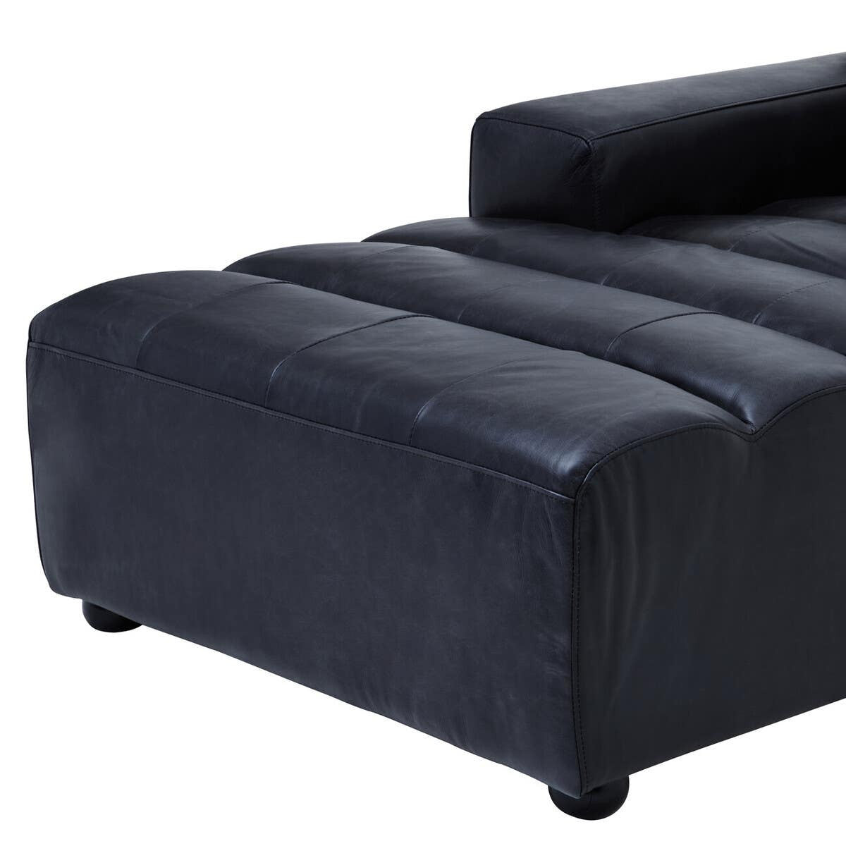 Left arm of a modular chaise sofa featuring a sleek antique black leather upholstery, with a smooth, curved design and plush seating area. The base is supported by rounded feet, enhancing its modern aesthetic