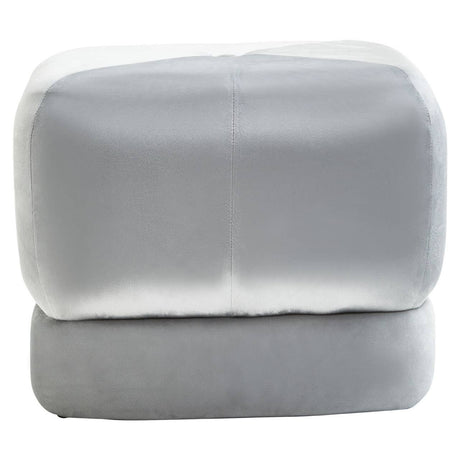 Square stool upholstered in soft grey velvet with a smooth, rounded top and clean lines, featuring a minimalist design that complements modern home decor