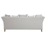 Three-seat sofa upholstered in grey fabric with a sleek, modern design, featuring a curved back and four decorative cushions on the seat. The sofa stands on light wooden legs, showcasing a minimalist aesthetic suitable for contemporary living spaces