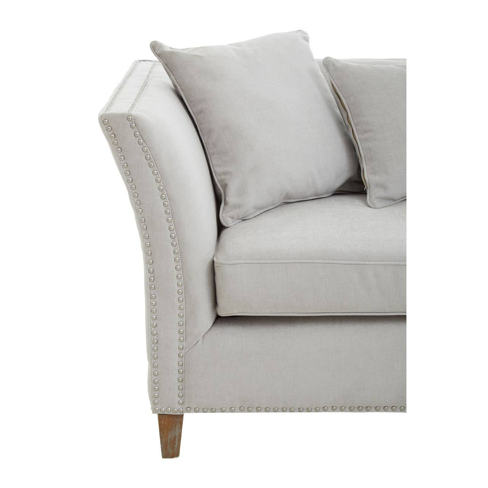 Three-seat sofa in grey fabric featuring a curved armrest and plush cushions, supported by wooden legs. The design is modern and inviting, suitable for various living room styles