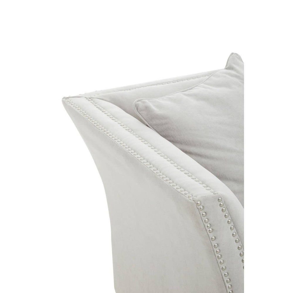 A close-up view of the armrest of the Sutton Two Seat Grey Fabric Sofa, showcasing its soft grey fabric and clean, modern lines. The armrest has a gently curved shape, emphasizing a contemporary design