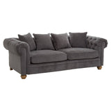 Three-seat sofa upholstered in grey fabric featuring a tufted backrest and rolled arms, complemented by four matching throw pillows and wooden legs