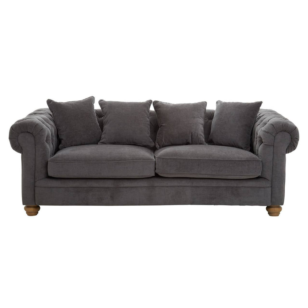 Three-seat sofa upholstered in grey fabric, featuring a classic design with rolled arms and four matching cushions. The sofa rests on wooden legs, showcasing a sturdy and elegant appearance suitable for various living spaces