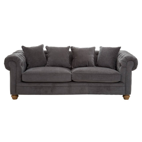 Three-seat sofa upholstered in grey fabric, featuring a classic design with rolled arms and four matching cushions. The sofa rests on wooden legs, showcasing a sturdy and elegant appearance suitable for various living spaces