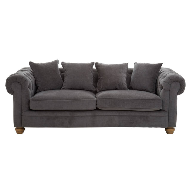 Three-seat sofa upholstered in grey fabric, featuring a classic design with rolled arms and four matching cushions. The sofa rests on wooden legs, showcasing a sturdy and elegant appearance suitable for various living spaces