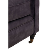 Close-up view of the corner of a two-seat sofa upholstered in grey velvet, featuring a sleek design with a slightly curved armrest and elegant wooden legs. The texture of the fabric is soft and plush, highlighting its luxurious appearance