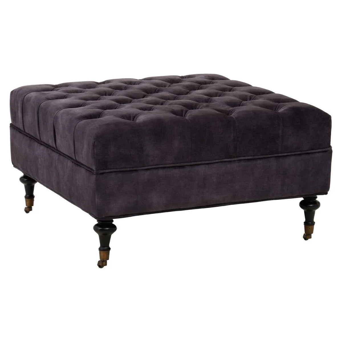 Dark grey velvet ottoman with deep button tufting and turned wooden legs on castors