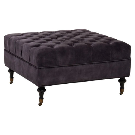 Dark grey velvet ottoman with deep button tufting and turned wooden legs on castors