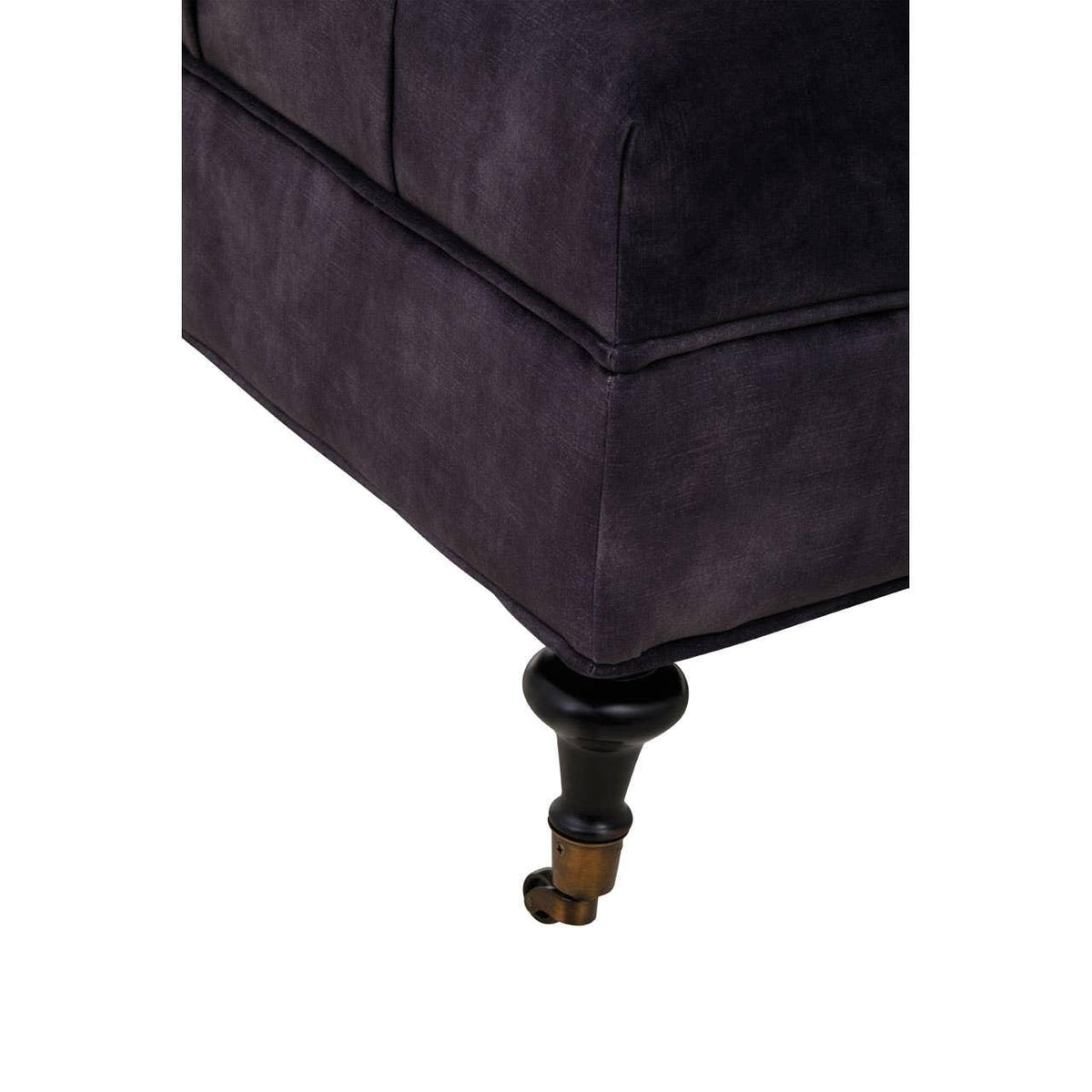Close-up of dark fabric sofa corner with turned wooden leg and caster