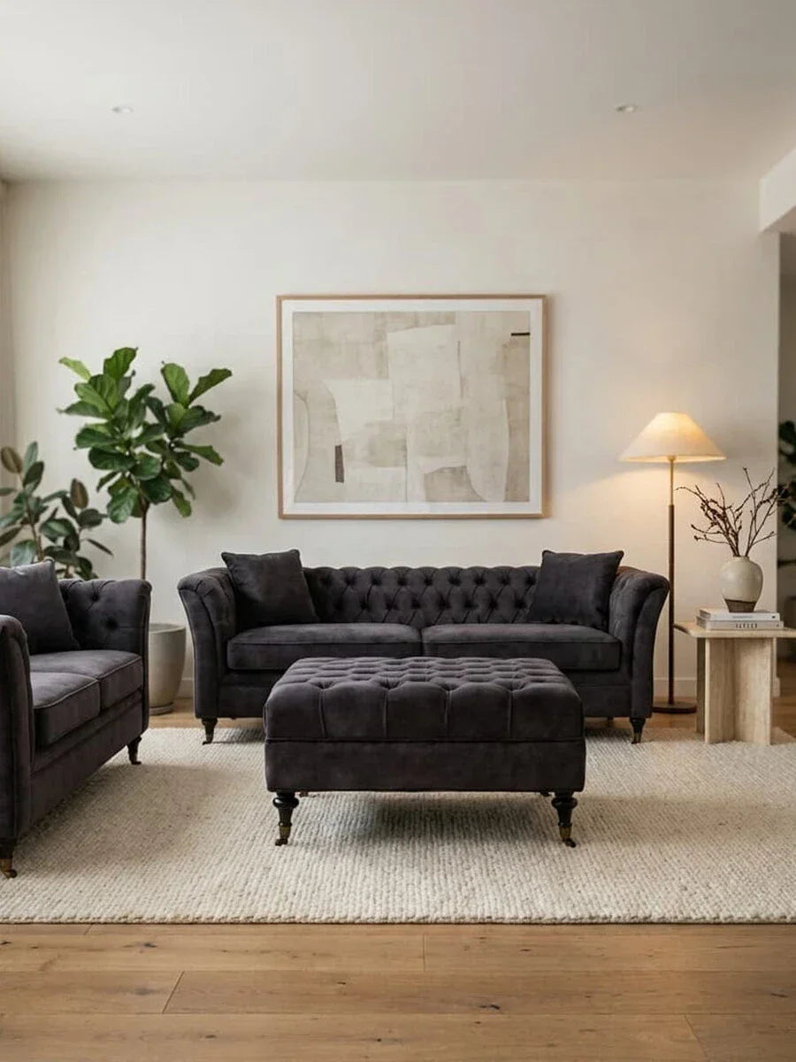 Charcoal velvet chesterfield sofa set with matching ottoman and armchair in modern living room