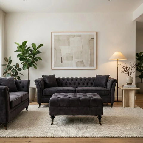 Dark grey velvet sofa set with matching ottoman on cream rug in modern living room