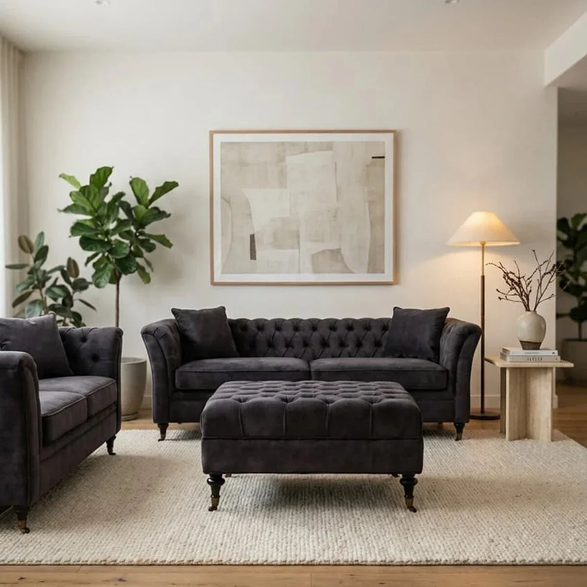 Dark grey velvet sofa set with matching ottoman on cream rug in modern living room