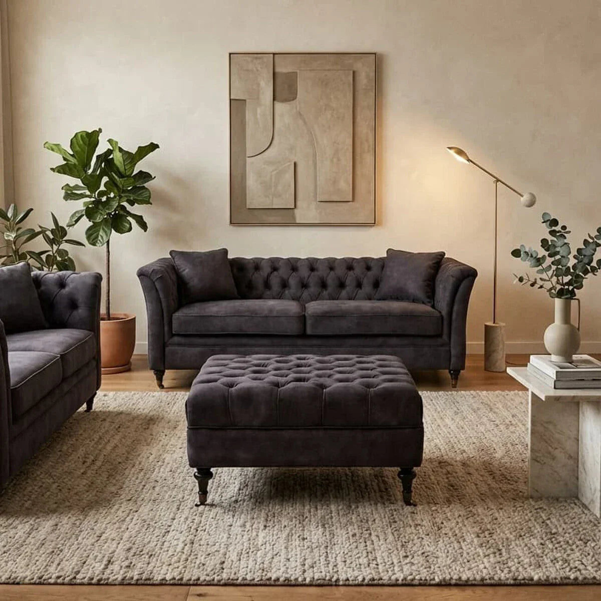 Dark grey velvet sofa set with matching ottoman in modern living room with decor accents