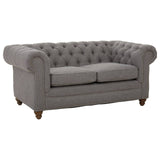 Two-seat sofa upholstered in grey linen with tufted backrest and rolled arms, featuring wooden legs