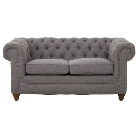 Two-seat sofa upholstered in grey linen with a tufted backrest and rolled arms, featuring wooden legs. The cushions are plush and inviting, designed for comfort and style